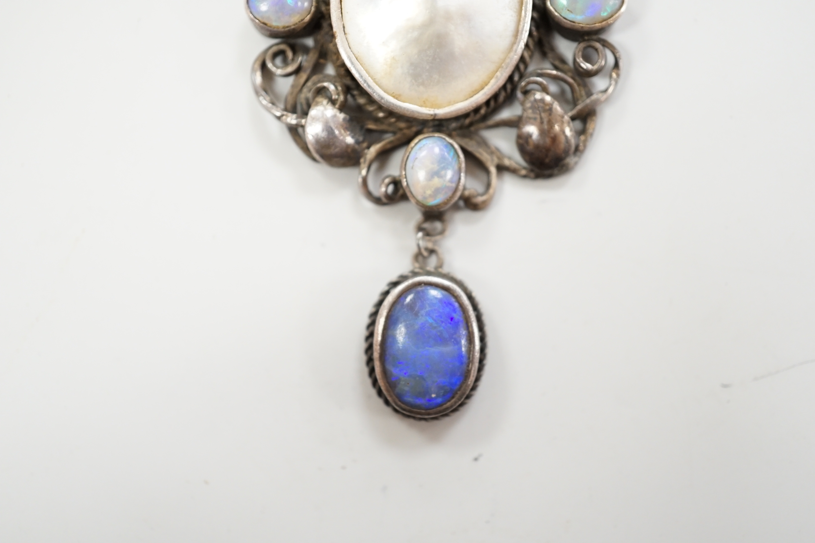 An Arts & Crafts white metal, mother of pearl and gem set drop pendant necklace, in the manner of Sybil Dunlop, overall 56cm.